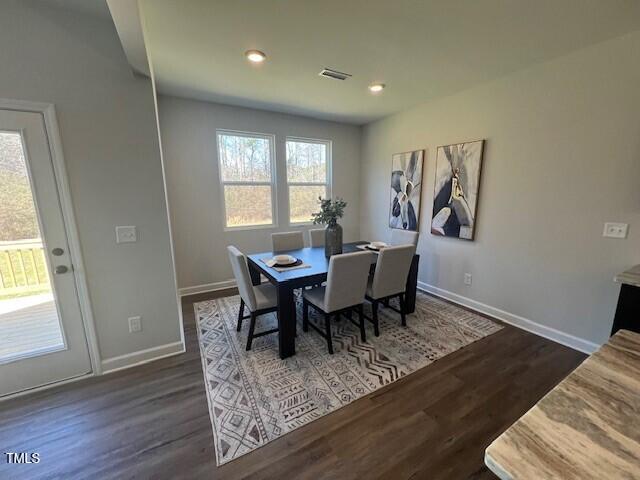 dining space with dark wood-type flooring