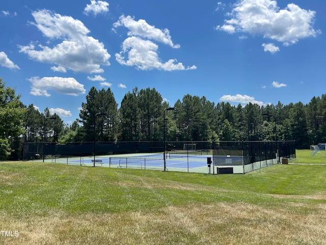 view of sport court with a lawn