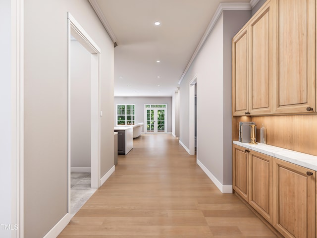 corridor with crown molding and light hardwood / wood-style floors