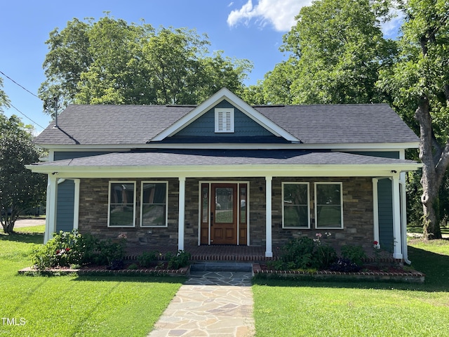 223 E Nash St, Spring Hope, NC 27882 - bungalow-style house with a porch, a front lawn, stone siding, and a shingled roof