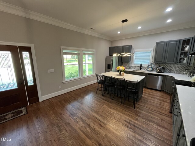 223 E Nash St, Spring Hope, NC 27882 - kitchen featuring tasteful backsplash, a kitchen island, a breakfast bar area, appliances with stainless steel finishes, and a sink