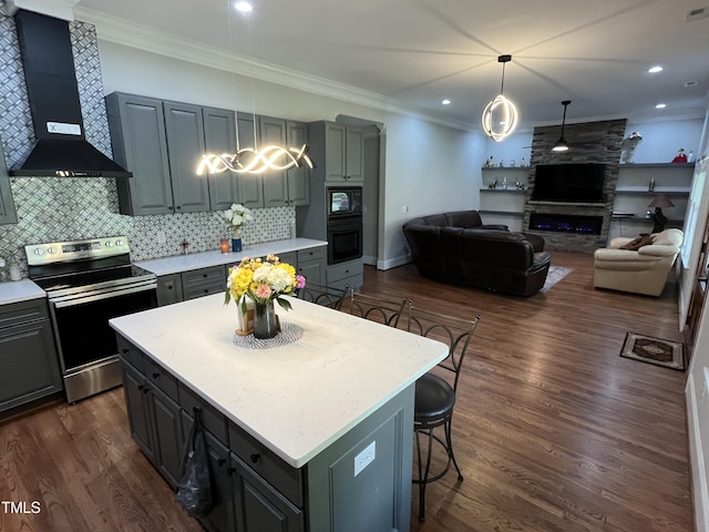 223 E Nash St, Spring Hope, NC 27882 - kitchen with wall chimney range hood, light countertops, black appliances, and ornamental molding