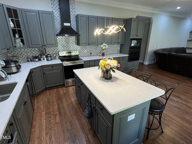 223 E Nash St, Spring Hope, NC 27882 - kitchen featuring crown molding, wall chimney exhaust hood, black appliances, gray cabinetry, and dark wood-style floors