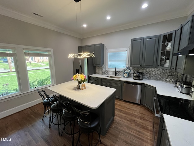 223 E Nash St, Spring Hope, NC 27882 - kitchen featuring tasteful backsplash, a breakfast bar, gray cabinets, a sink, and stainless steel appliances