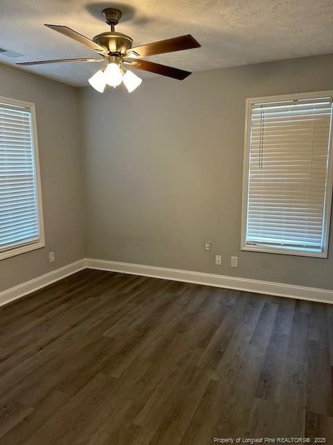 unfurnished room with a textured ceiling, ceiling fan, and dark wood-type flooring