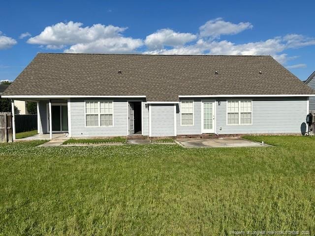 rear view of house with a yard