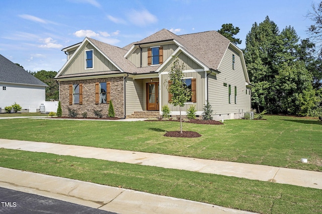 craftsman-style home featuring a front yard and central air condition unit