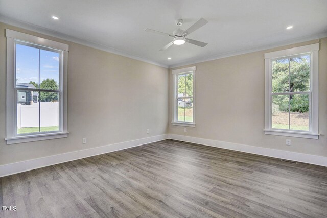 unfurnished room featuring a healthy amount of sunlight, ornamental molding, hardwood / wood-style floors, and ceiling fan