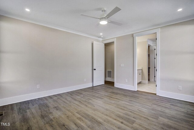 unfurnished room featuring wood-type flooring, ceiling fan, and crown molding