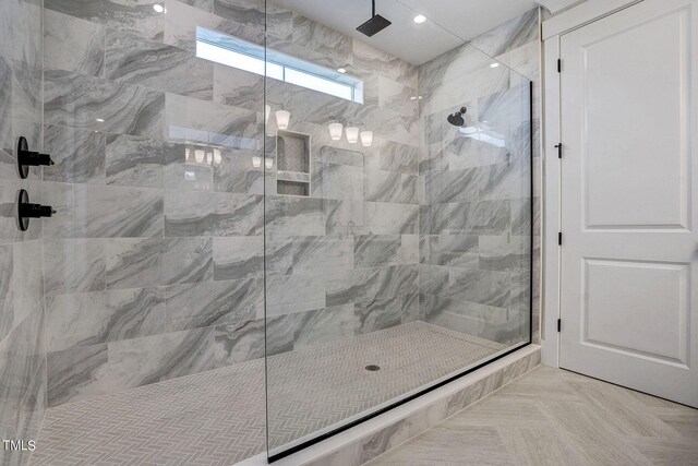 bathroom featuring parquet flooring and a shower with shower door