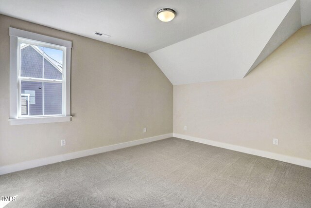 bonus room featuring carpet and vaulted ceiling