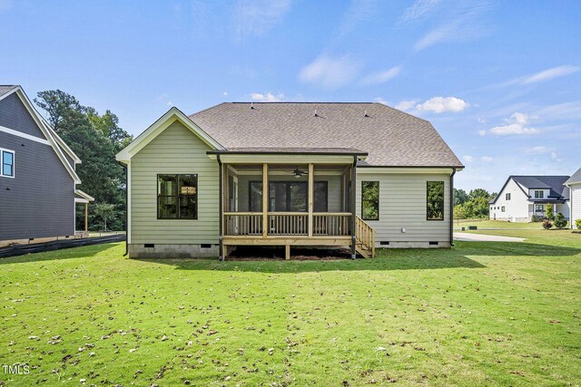 back of house with a lawn and a sunroom