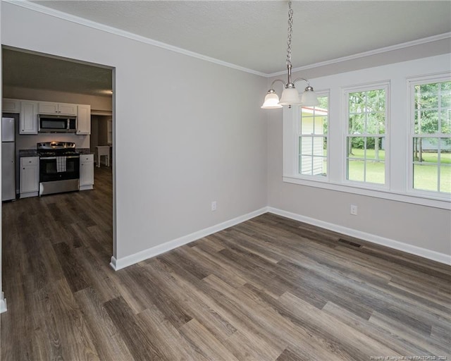 unfurnished dining area with dark hardwood / wood-style flooring, ornamental molding, and an inviting chandelier