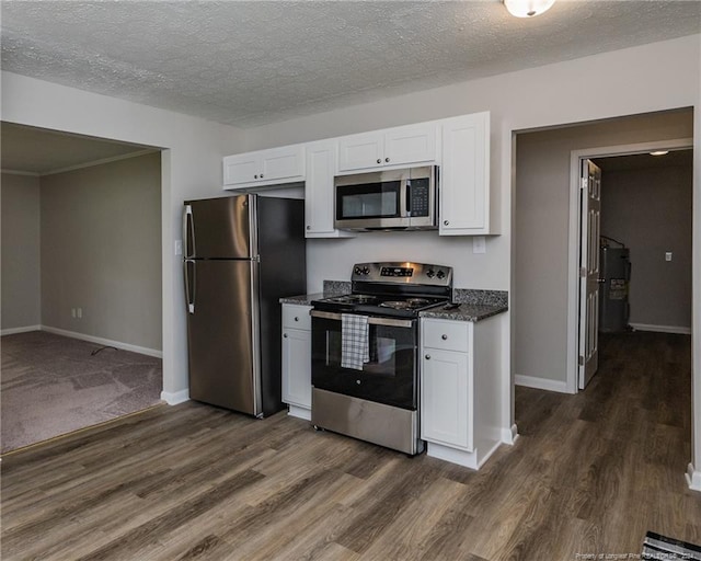 kitchen with white cabinets, stainless steel appliances, and dark wood-type flooring