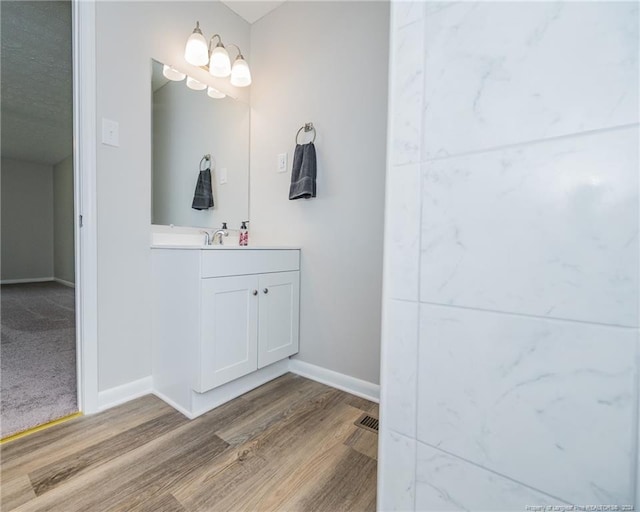 bathroom with hardwood / wood-style floors and vanity