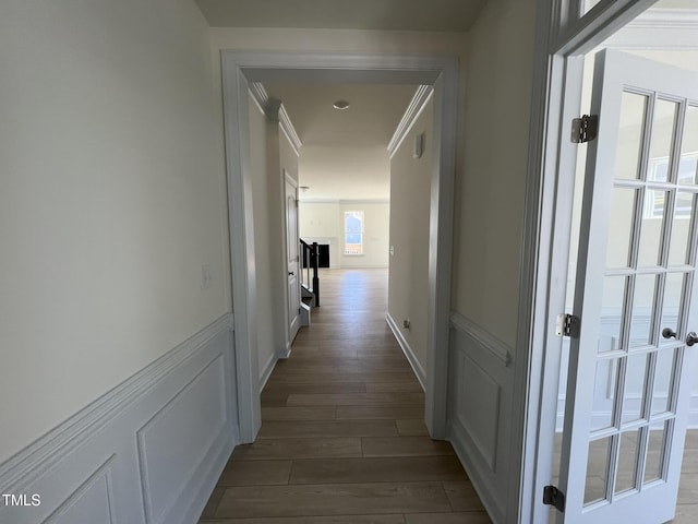 hallway with dark hardwood / wood-style flooring and crown molding