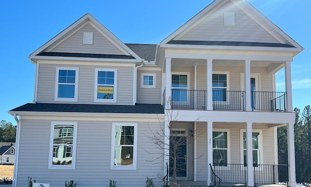 view of front of property featuring a balcony and covered porch