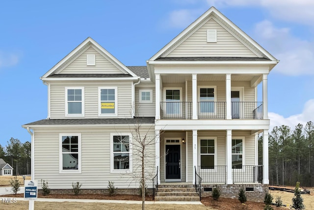 view of front of house with a balcony and covered porch