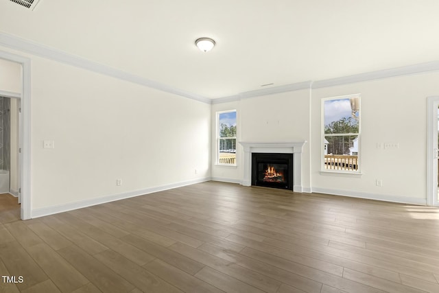 unfurnished living room featuring crown molding and hardwood / wood-style flooring