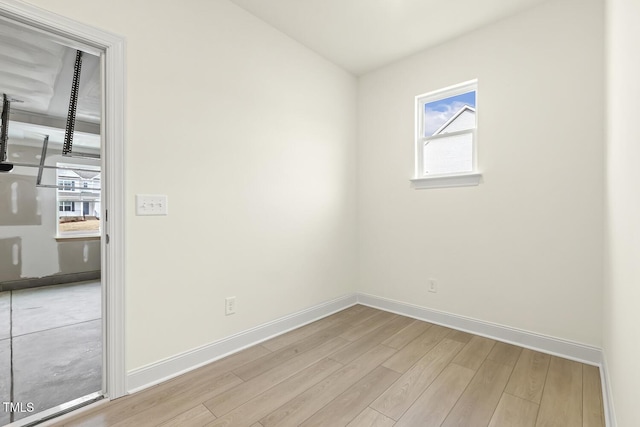 spare room featuring plenty of natural light and light wood-type flooring