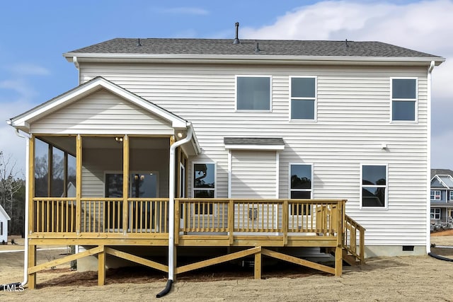 back of house featuring a sunroom and a deck