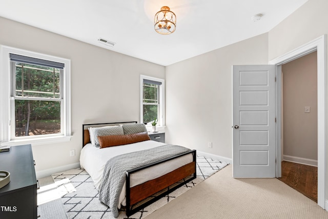 3209 Bryant Falls Ct, Raleigh, NC 27613 - bedroom with multiple windows, baseboards, and carpet floors