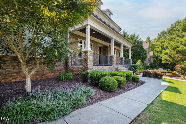 3209 Bryant Falls Ct, Raleigh, NC 27613 - entrance to property with a porch, stone siding, and a yard