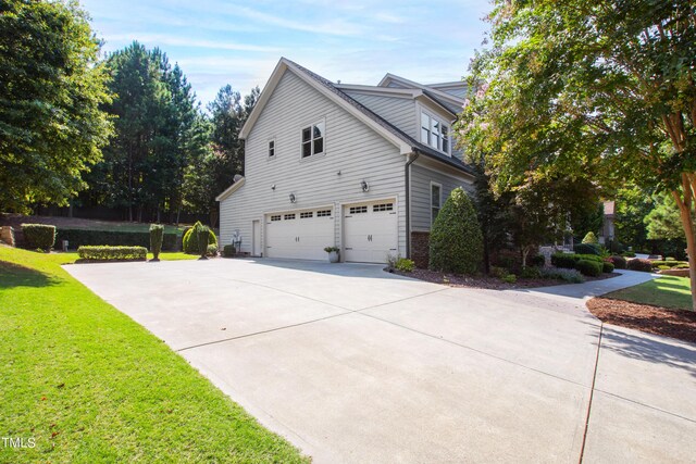 3209 Bryant Falls Ct, Raleigh, NC 27613 - view of side of property featuring an attached garage, concrete driveway, and a lawn