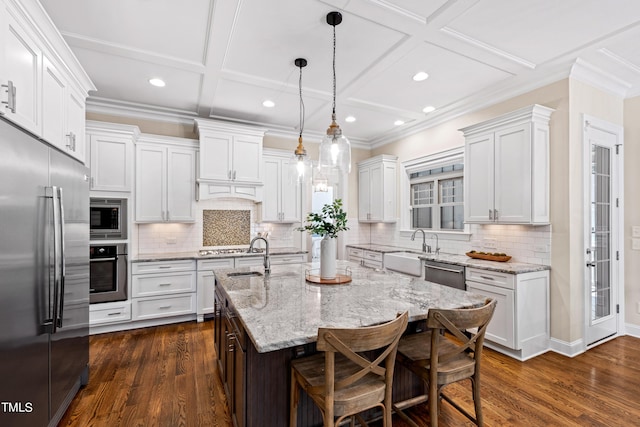 3209 Bryant Falls Ct, Raleigh, NC 27613 - kitchen featuring built in appliances, coffered ceiling, an island with sink, recessed lighting, and a sink