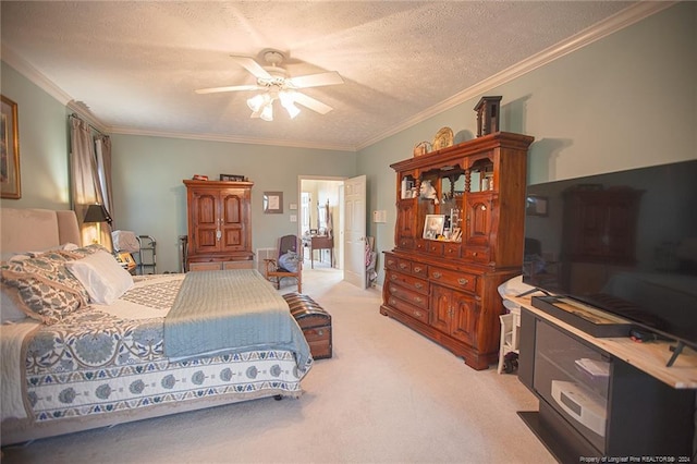 carpeted bedroom featuring ceiling fan, ornamental molding, and a textured ceiling