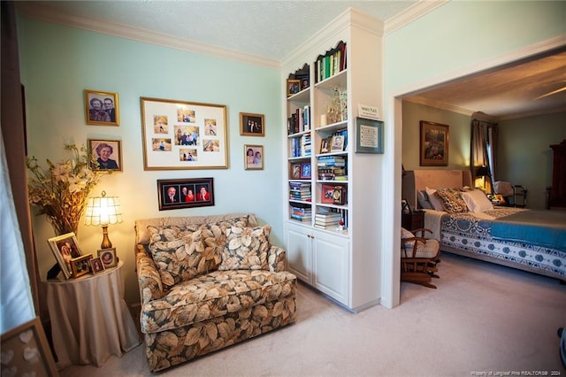 sitting room with ornamental molding and light colored carpet