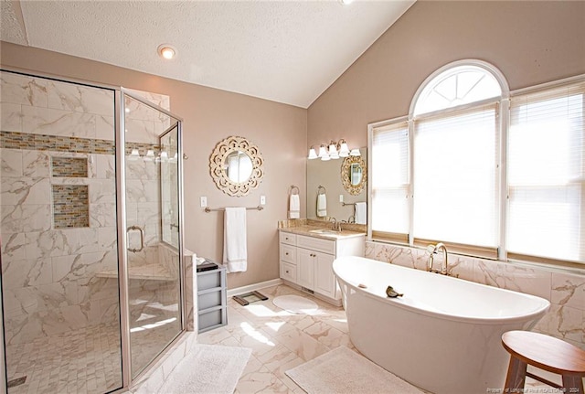 bathroom with vanity, vaulted ceiling, shower with separate bathtub, and a textured ceiling