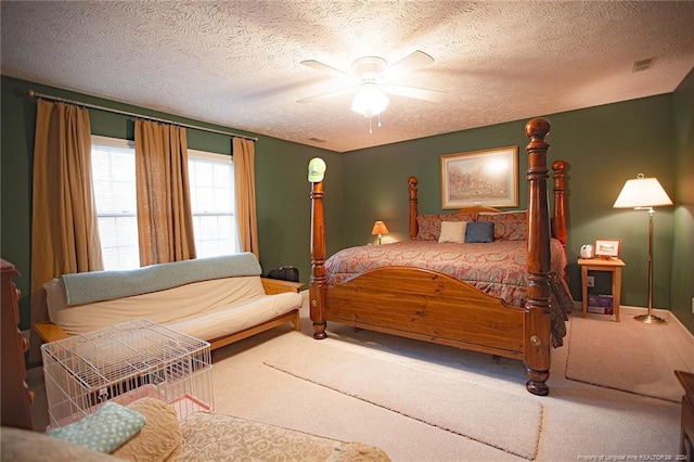 carpeted bedroom featuring a textured ceiling and ceiling fan