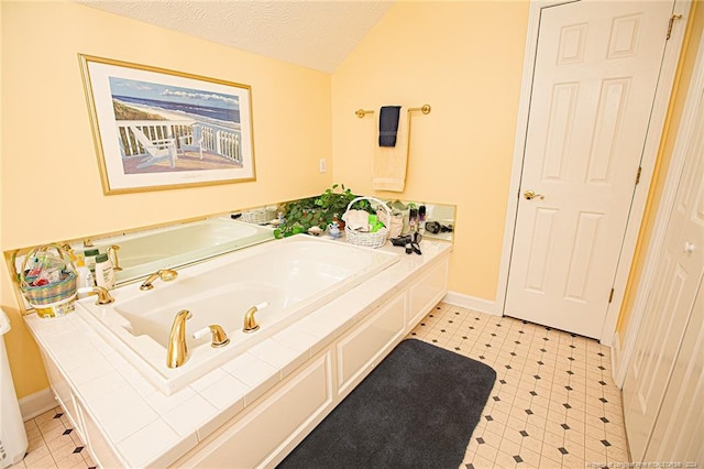 bathroom featuring lofted ceiling, a textured ceiling, and a washtub