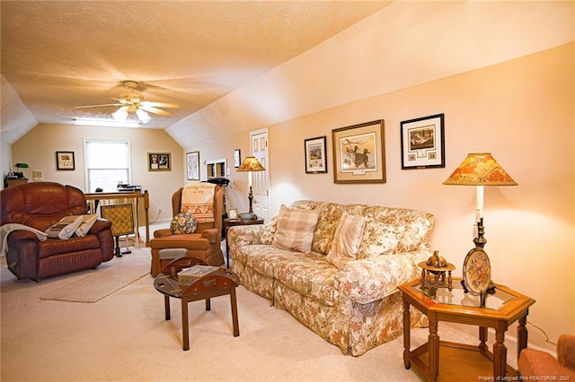 living room with vaulted ceiling, light colored carpet, ceiling fan, and a textured ceiling