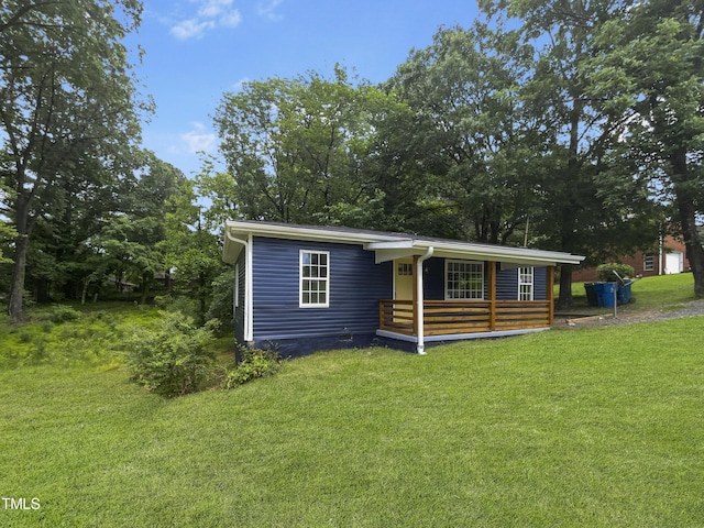 view of front of home featuring covered porch and a front yard