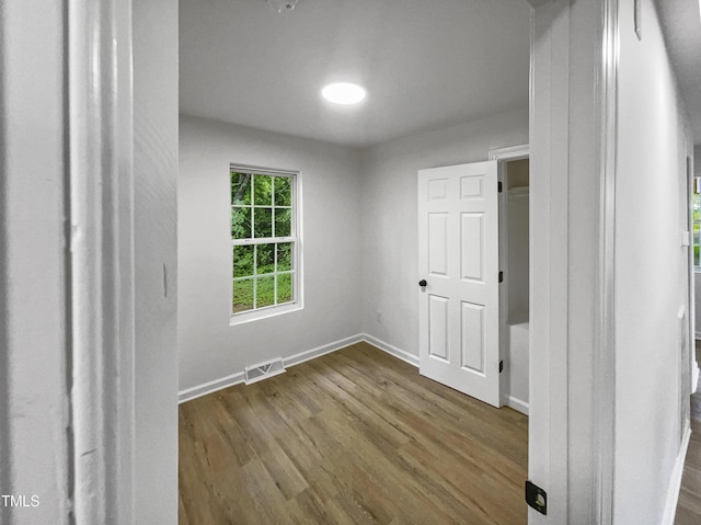 unfurnished bedroom with wood-type flooring