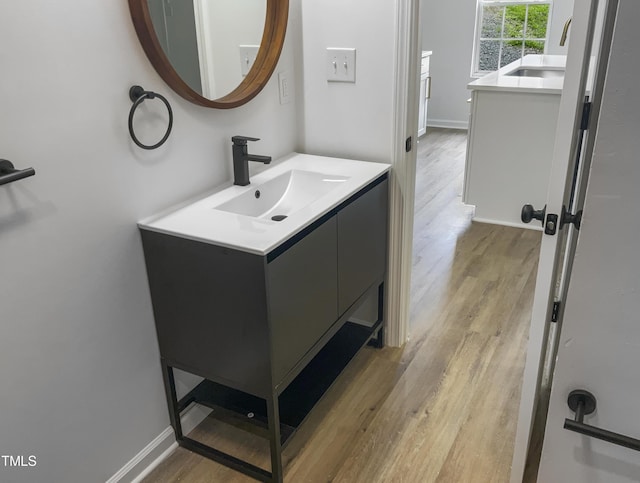 bathroom with vanity and hardwood / wood-style flooring