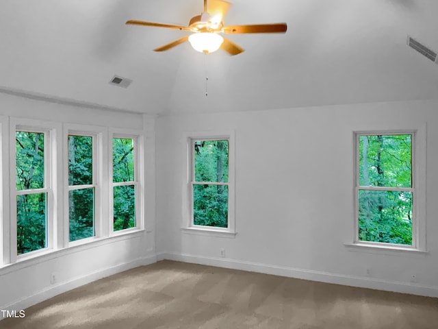 carpeted empty room with ceiling fan and vaulted ceiling