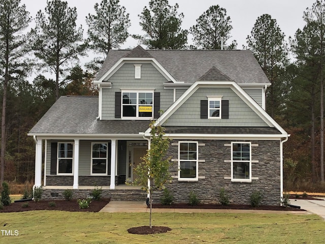 craftsman-style home featuring a front yard and a porch