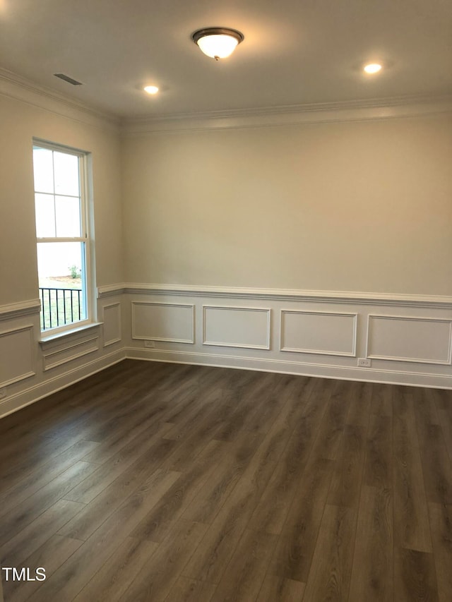 unfurnished room with dark wood-type flooring and ornamental molding