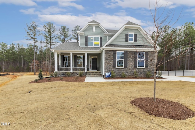 craftsman-style home featuring a porch and a front yard