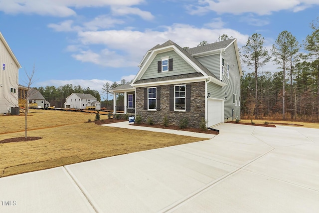 view of front of house with a garage and central air condition unit