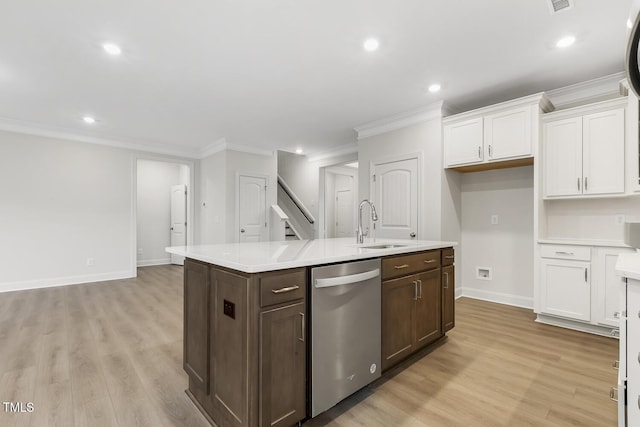 kitchen featuring sink, light hardwood / wood-style flooring, dishwasher, a kitchen island with sink, and white cabinets