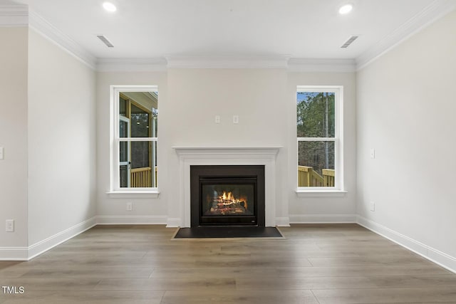 unfurnished living room with crown molding and hardwood / wood-style floors