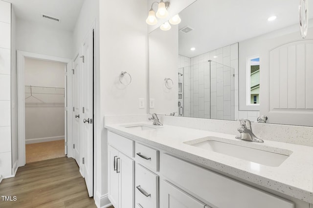 bathroom with an enclosed shower, hardwood / wood-style floors, and vanity