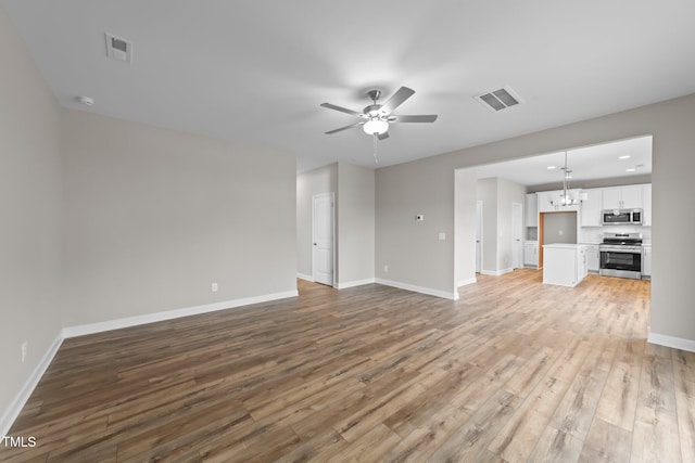 unfurnished living room with light hardwood / wood-style flooring and ceiling fan with notable chandelier