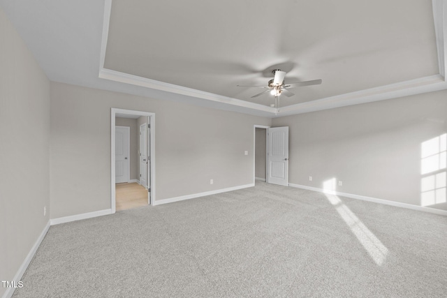 535 Husketh Rd, Youngsville, NC 27596 - empty room featuring a raised ceiling, light carpet, and a ceiling fan