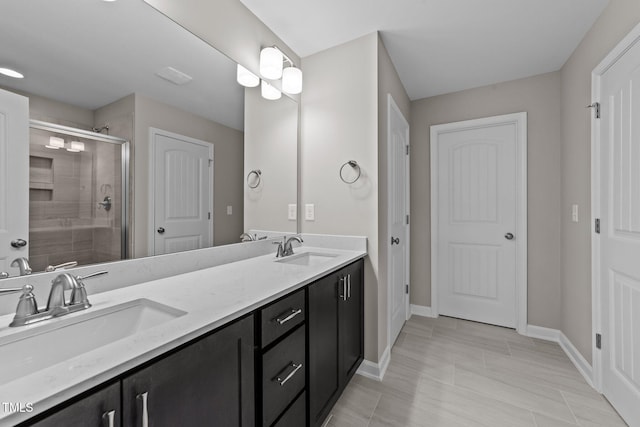 bathroom featuring vanity and a shower with door