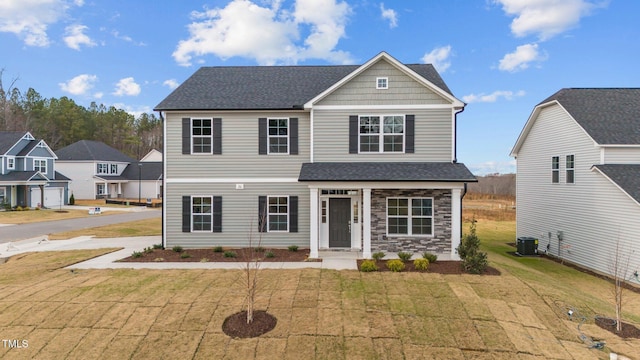 535 Husketh Rd, Youngsville, NC 27596 - view of front of property with a front yard, stone siding, and a shingled roof
